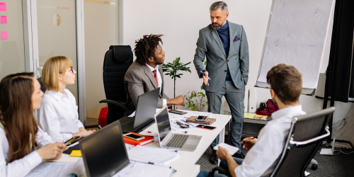 small local business team sitting around a table, discussing marketing ideas
